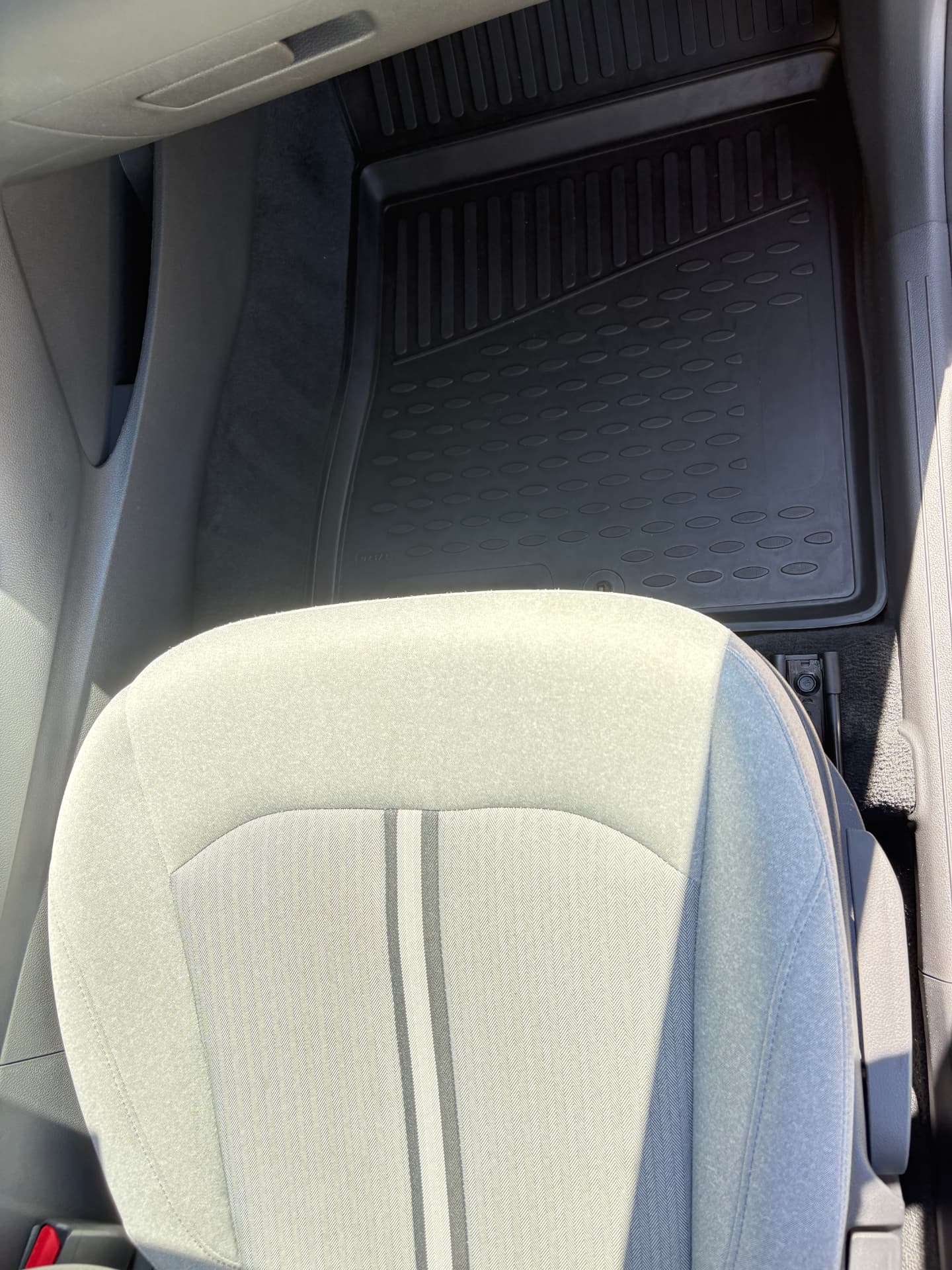 Clean front seat, floor mat and door sill after a full interior detail