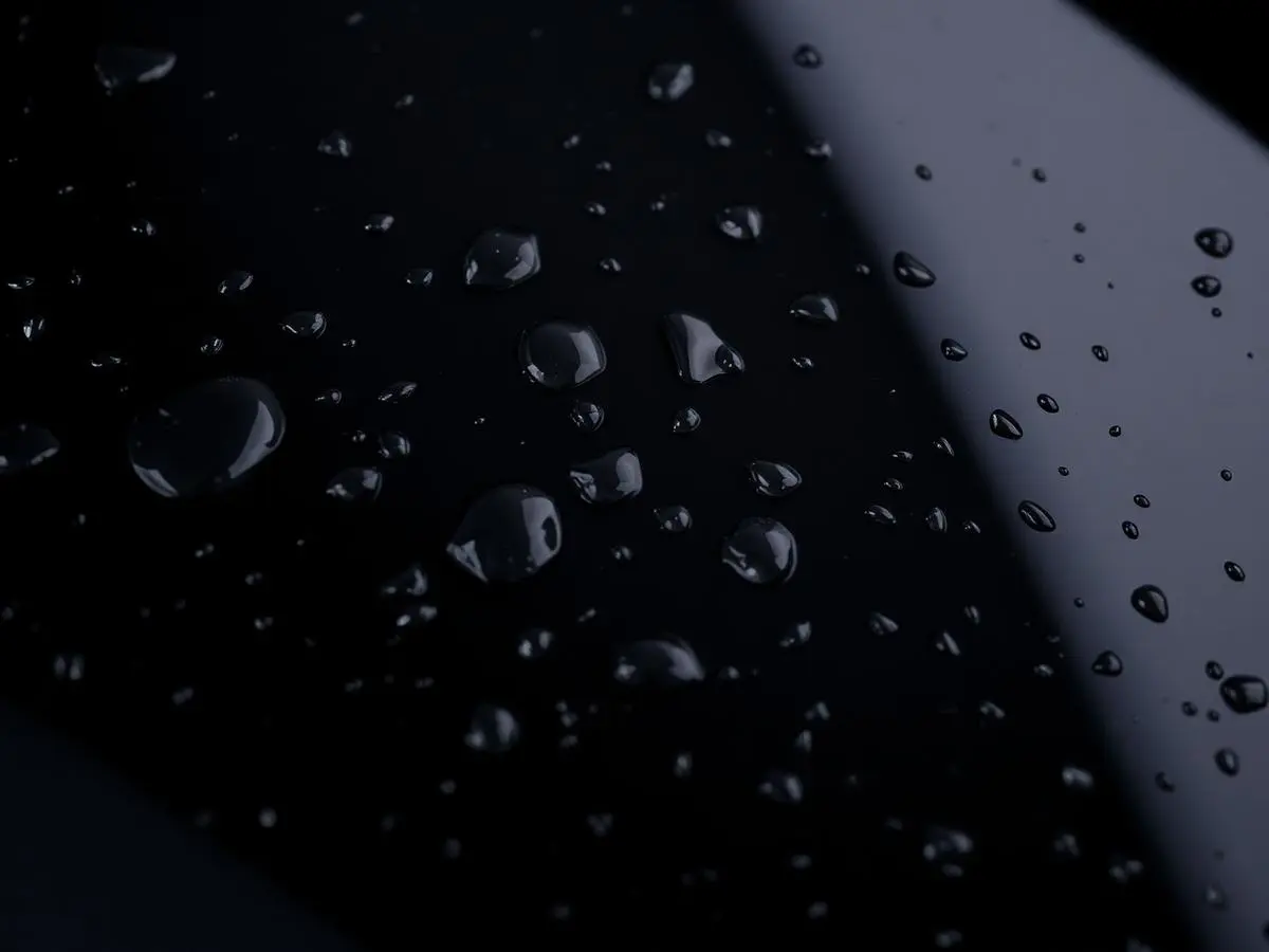 Water beading tightly on freshly ceramic coated black car paint
